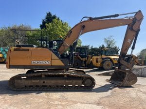 CX250D excavator with a long arm and bucket, positioned on a construction site with machinery in the background.